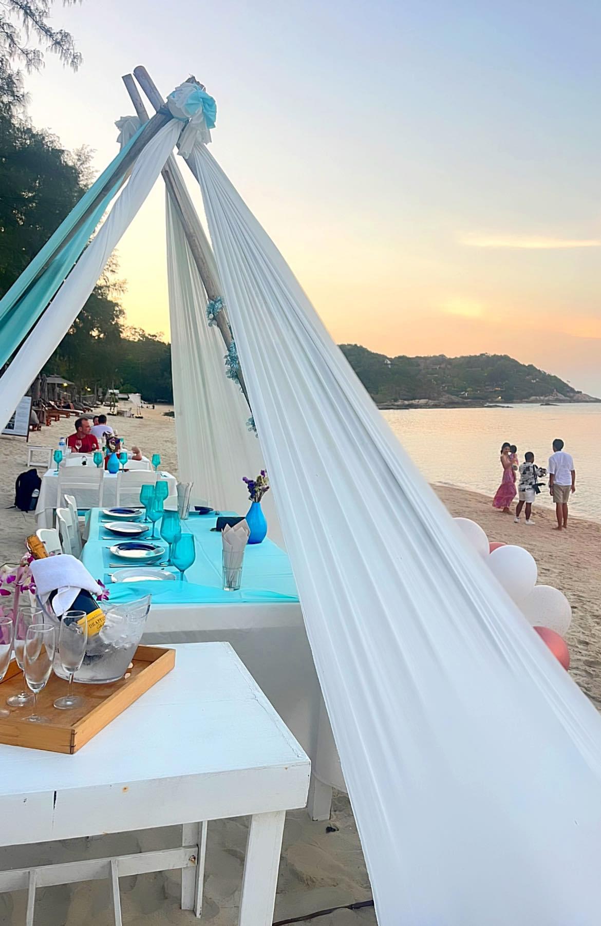 Champagne at sunset — tent canopy framing the bay, romantic and private